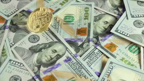 Bitcoin Spinning on Pile of One Hundred Dollar Bills