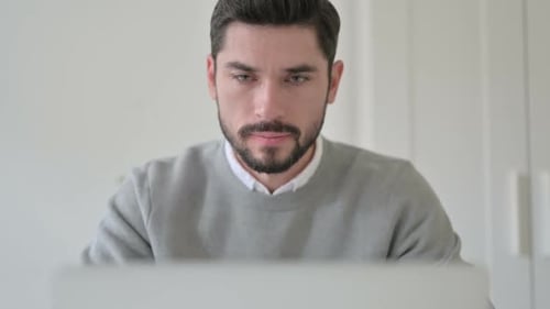 Close Up of Man Working on Laptop