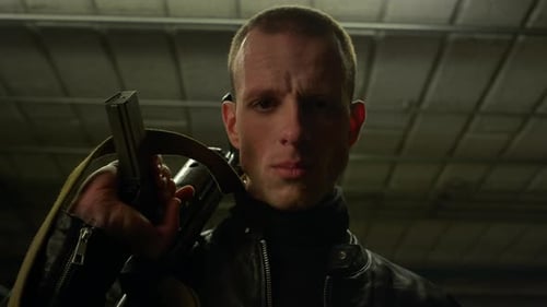 Intense Man Holding a Firearm in Dark Garage