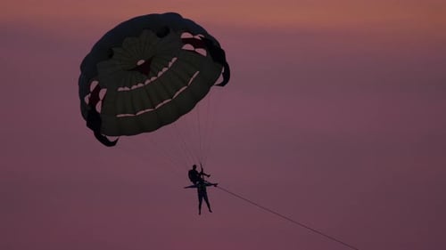 Couple Parasailing at Sunrise