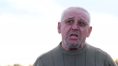 Old Grayhaired Man Looking at the Camera and Smiling Mature Grandfather Close Up