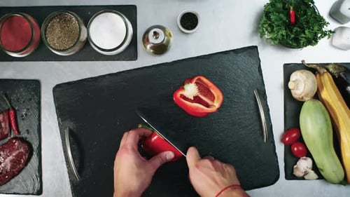 Hands Cutting Red Bell Pepper in Kitchen