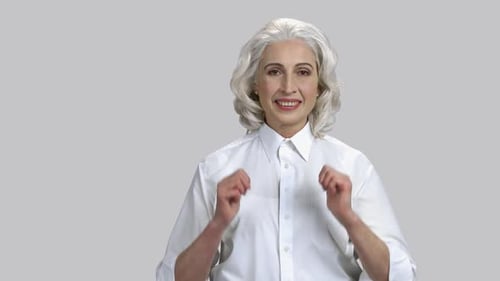 Smiling Mature Woman Gives Double Thumbs Up