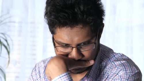 Man with Glasses Thinking, Hand on Chin