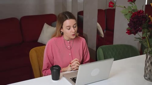 Woman on Laptop Video Call at Home