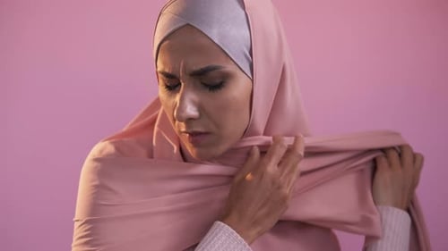 Woman in Head Covering Looking at Camera