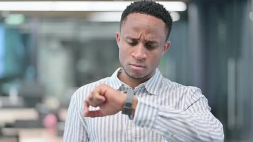Young Man Checking Time on Smartwatch