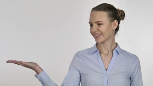 Woman Presenting with Open Palm Against White Background