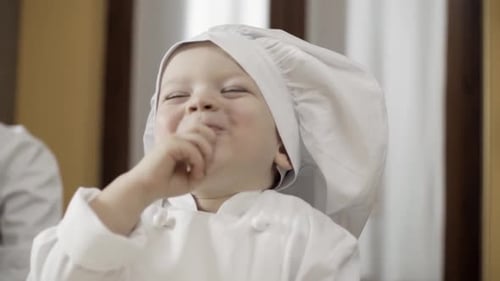Infant Chef Tastes Food in Kitchen