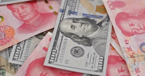 American Dollars and Chinese Yuan Pile Close-Up