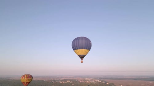 Colorful Hot Air Balloons Flying Over Green Park in Small European City at Summer Sunrise, Aerial