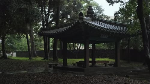 A traditional Korean pavilion in a rainy park. Text means 'House to Miss Special