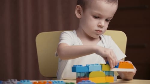 Focused Child Builds with Colorful Plastic Blocks