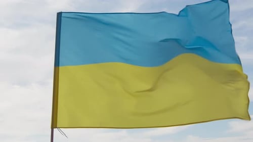 Flag Waving Against Cloudy Sky