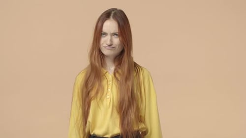 Woman Expressing Dislike with a Thumbs Down Gesture