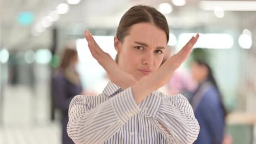 Portrait of Serious Young Woman Saying No By Arms Crossed