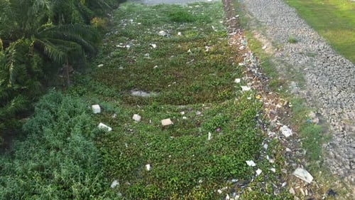 Fly over garbage dump on river.