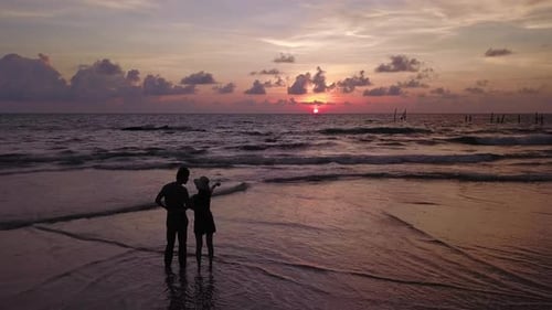 Happy Asian couple dating at the beach during travel honeymoon trip on holidays vacation