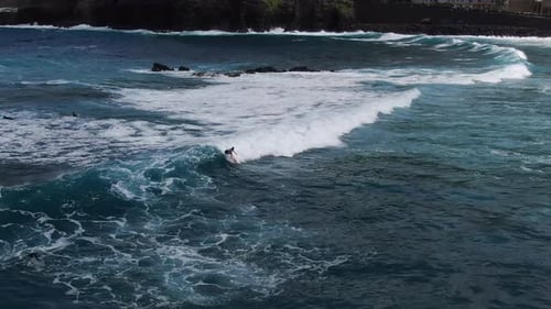 Aerial shot of surfers on the ocean waves