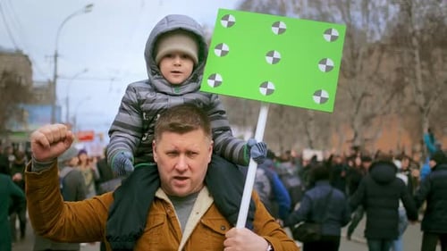 Father and Son Marching at Outdoor Rally