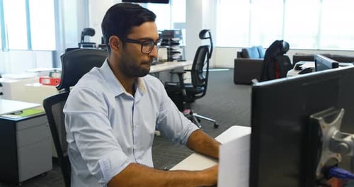 Man Working on Computer in Modern Office