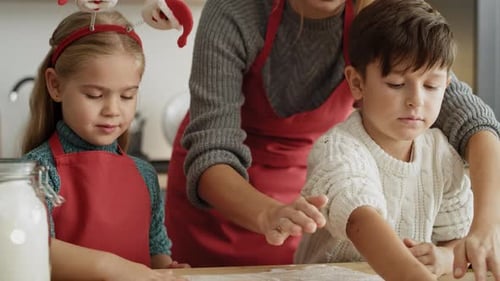 Family Baking Festive Cookies in Kitchen at Christmas
