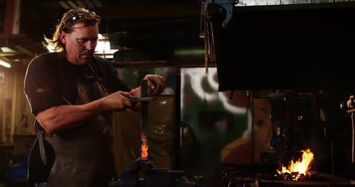 Blacksmith working at workshop
