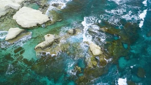 Aerial Top View Footage By Drone of Ocean Blue Waves Break on High Cliff of a Rocky Mountain