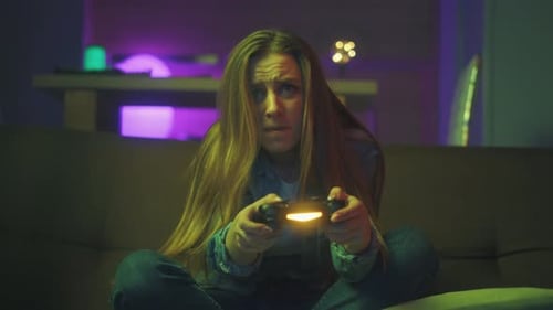 Young Woman Plays Video Game, Celebrates Winning
