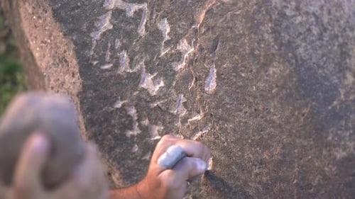 Ancient Man Cave Painting and Writing Historic Inscription Graffiti on Rock Surface With Iron Chisel