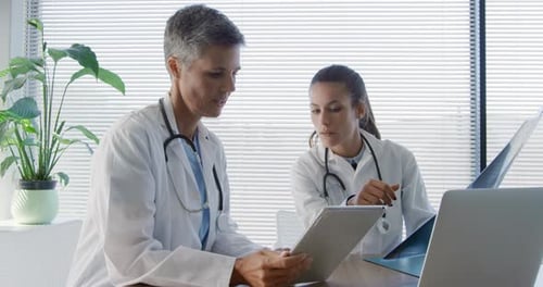 Doctors Reviewing X-Ray with Technology in Modern Office