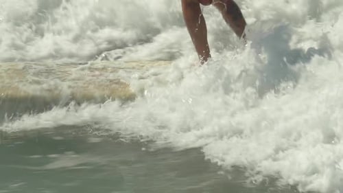 Man Surfing on a Wave on a Sunny Day