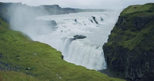 Powerful Waterfall Cascading Down Rocky Cliffs