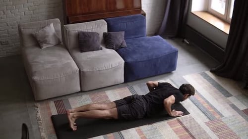Man Exercising Doing Push Ups on Yoga Mat