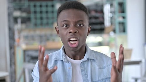Young Man Yelling and Gesturing with Anger