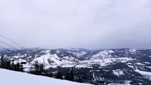 Skier Skiing Downhill in Winter Resort Mountains