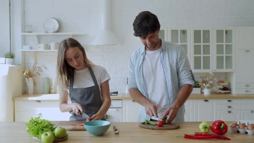 Couple Preparing Food Together in Sunny Kitchen