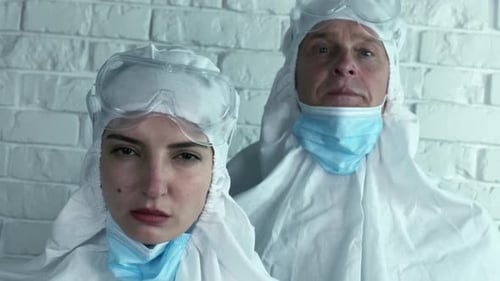 Medical Staff in White Protective Suits and Masks