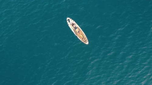 Woman Relaxing on Paddleboard in Ocean Aerial View