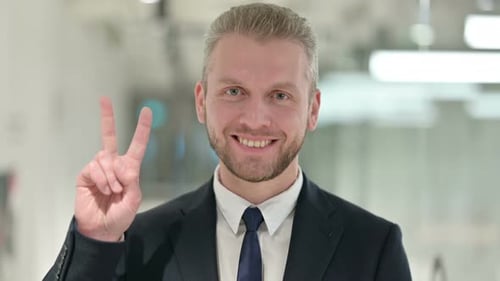 Businessman Smiling and Giving Peace Sign