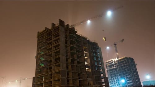 Construction site with crane night time lapse. Building of skyscrapers. Working tower cranes.