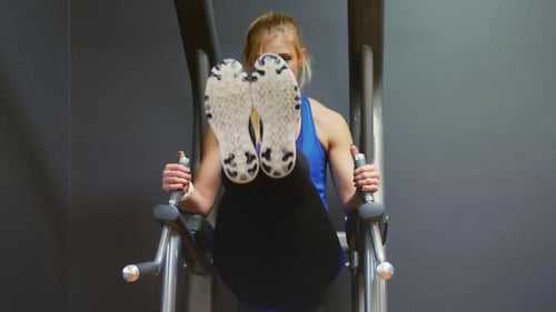 Woman Working Out Abs on Machine at Gym