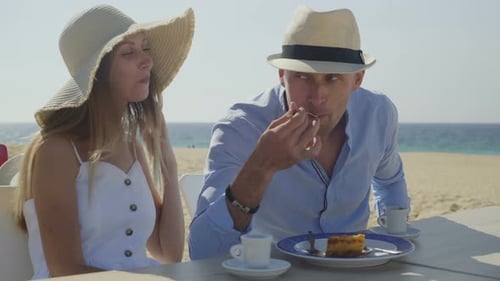 Couple Eating and Drinking on Beach