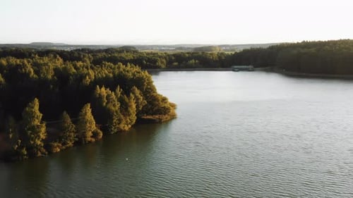 Gorgeous Peaceful Nature, Drone Flying Above Calm Autumn Lake Towards Green Forest During
