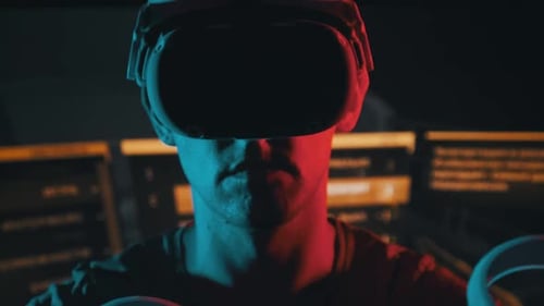 Man Wearing VR Headset in Red and Blue Lit Room