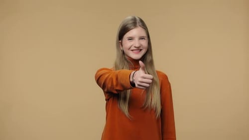 Young Woman Giving Thumbs Up, Smiling