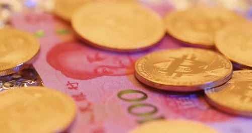 Bitcoin Coins on Chinese Yuan Currency Close Up