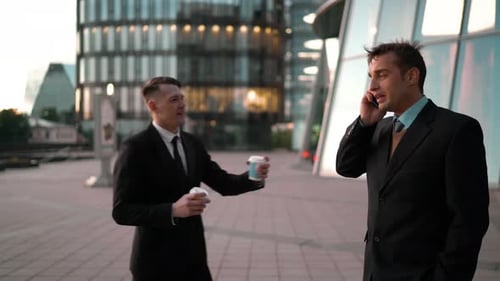 Businessmen Meeting and Talking in City