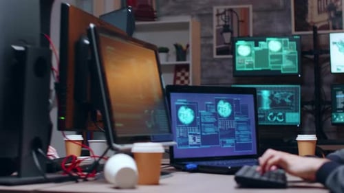 Workers Analyze Data at Computers in Office