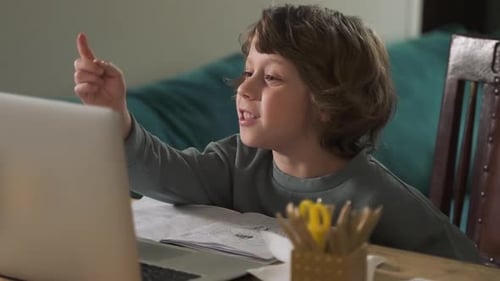 Boy Using Laptop Computer for Online Education at Home